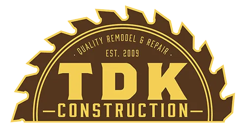 TDK Construction logo: yellow text